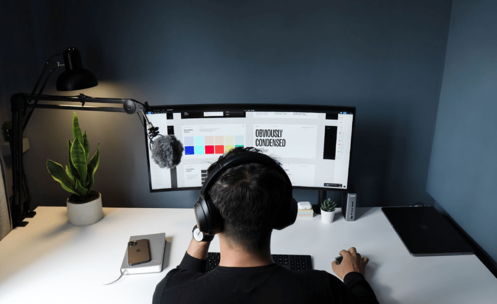 Designer wearing headphones working on a computer