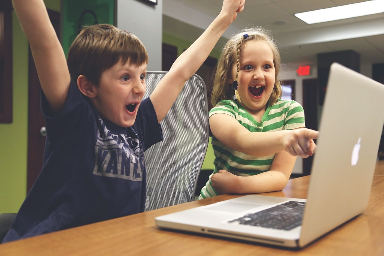 children celebrating at computer