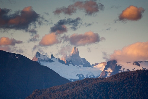 The Devil's Thumb can be seen near Petersburg, Alaska, one of the stops on the Columbia, one of the ships in the Alaska Marine Highway ferry system, which takes passenger through the Inside Passage of Alaska, on Sunday, July 14, 2013. Passengers have the option to stay in rooms for an extra fee or sleep on the top deck in either a tent or under the solarium. (Photo by Matthew Ryan Williams for The New York Times)