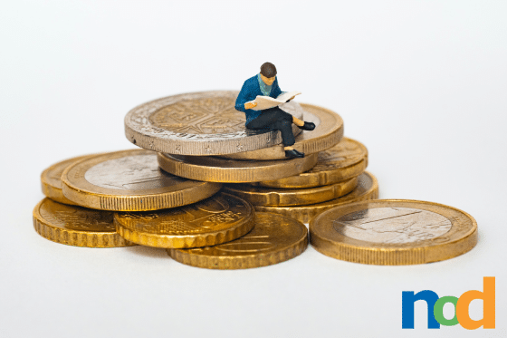 man sitting on coins